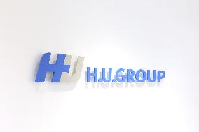 H.U. Group Holding Sign and Logo